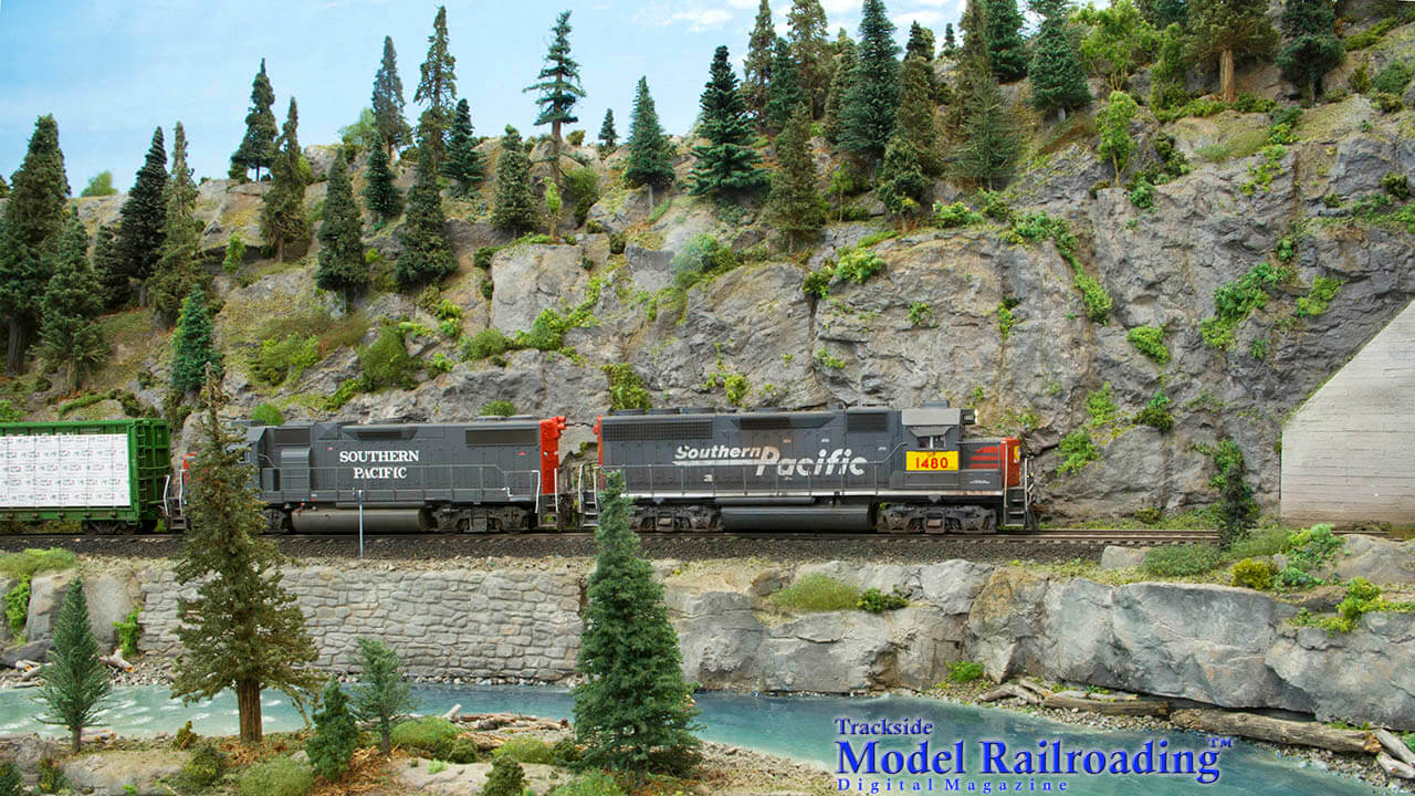  Trackside Model Railroading visits Mike McGinley’s Southwestern Pacific and it is an amazing HO scale layout. Imaged here in 2006, while fishing the Cascade River, a patched Southern Pacific Geep No. 1480 is on point of the daily Union Pacific eastbound local.